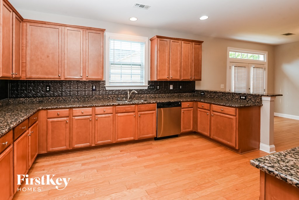 a kitchen with wooden cabinets and granite counter tops