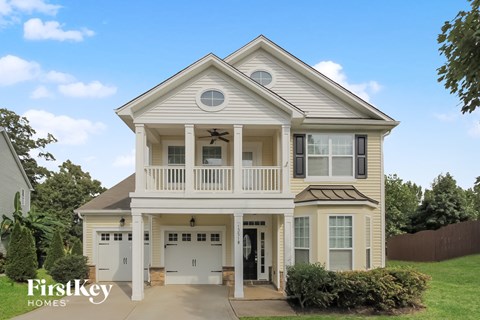 a white house with a porch and white doors