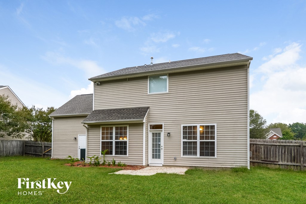 A house with a grey siding and a white door is shown with the words "FirstKey Homes" on the bottom left.