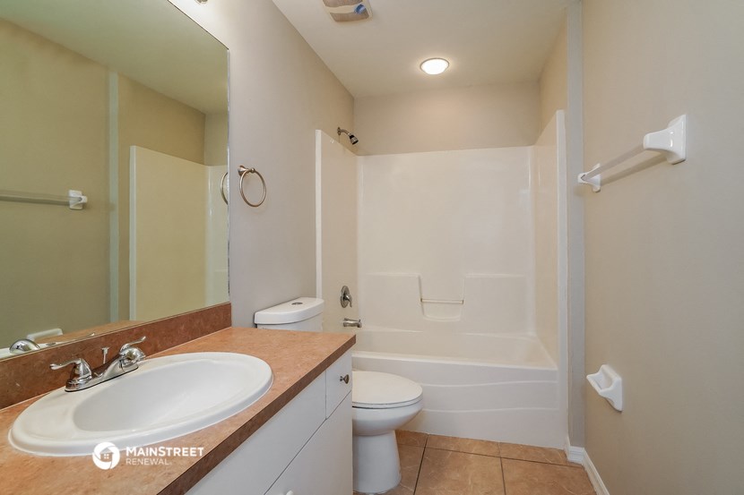 a bathroom with a sink and a toilet and a shower