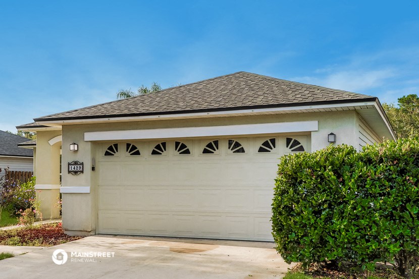 a white garage door in front of a house