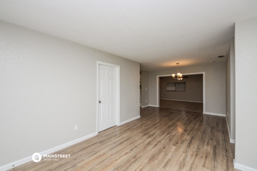 the living room and dining room of an apartment