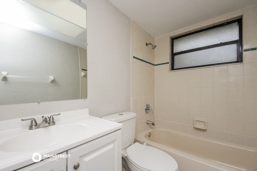 a bathroom with a sink toilet and a tub