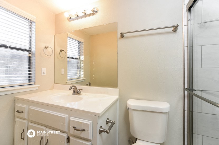 a bathroom with a sink toilet and a shower