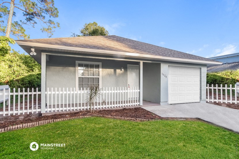 a white picket fence in front of a house