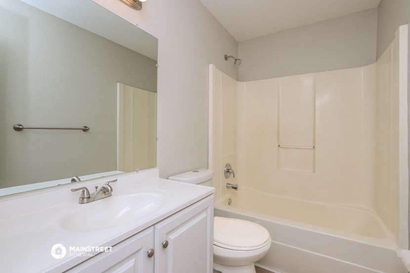 a bathroom with a sink and a toilet and a tub