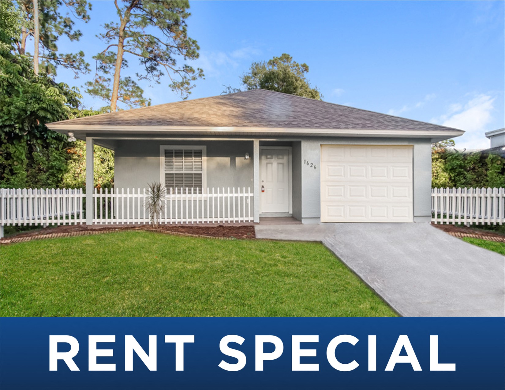 a home with a lawn and a white fence     and the words