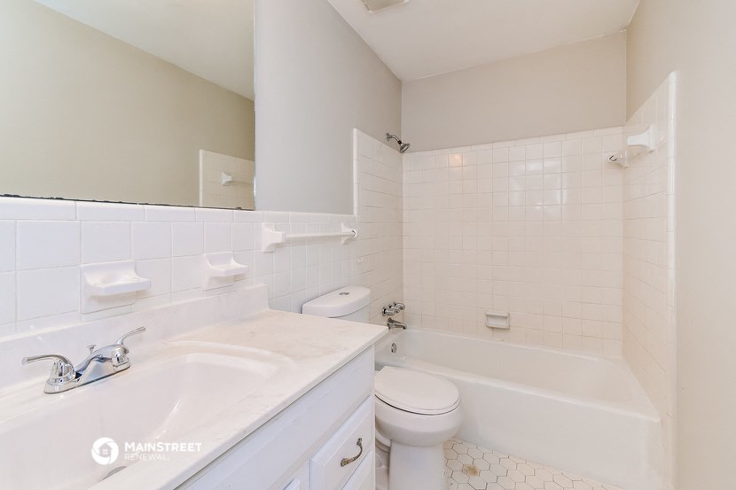 a bathroom with a sink toilet and a bath tub