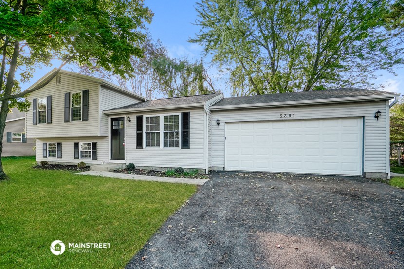 a white house with a white garage and a driveway