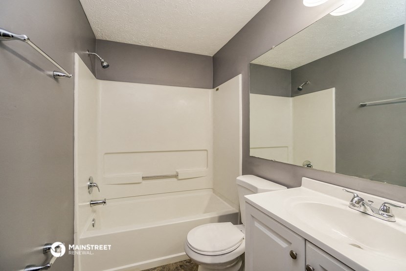a bathroom with a sink toilet and a bath tub