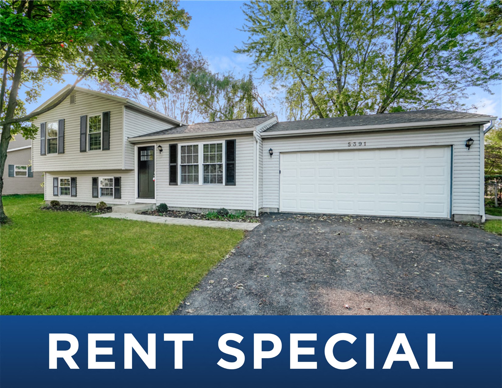 a white house with a driveway and a white garage door