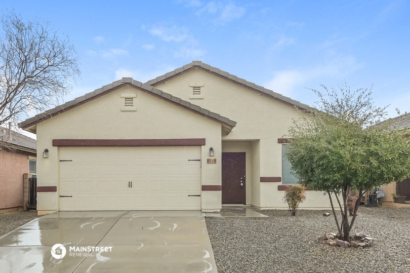 a house with a garage and a tree in front of it