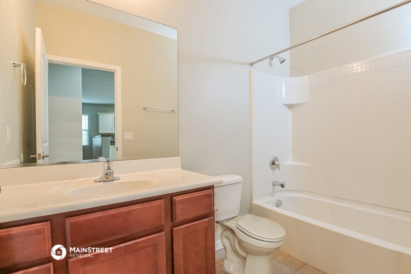 a bathroom with a sink toilet and a tub
