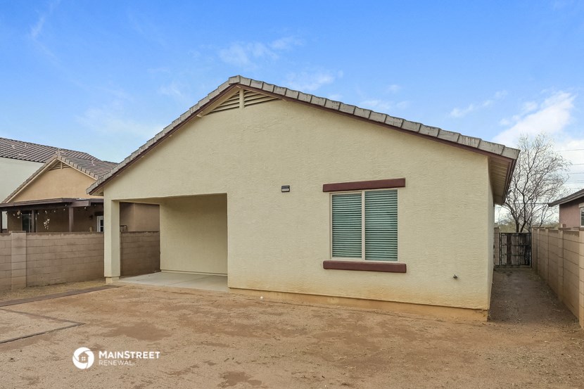 the exterior of a house with a driveway and a garage door