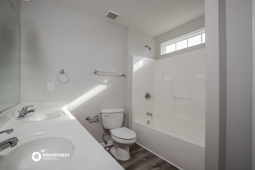 a bathroom with a sink and a toilet and a bath tub