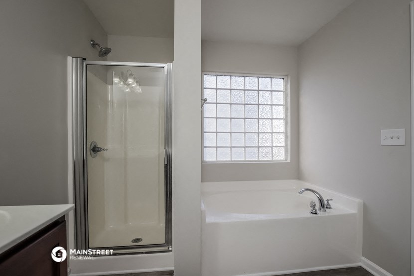 an empty bathroom with a tub and a shower