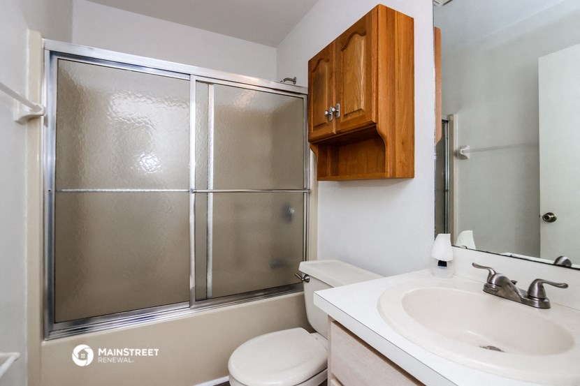 a bathroom with a sink toilet and a shower
