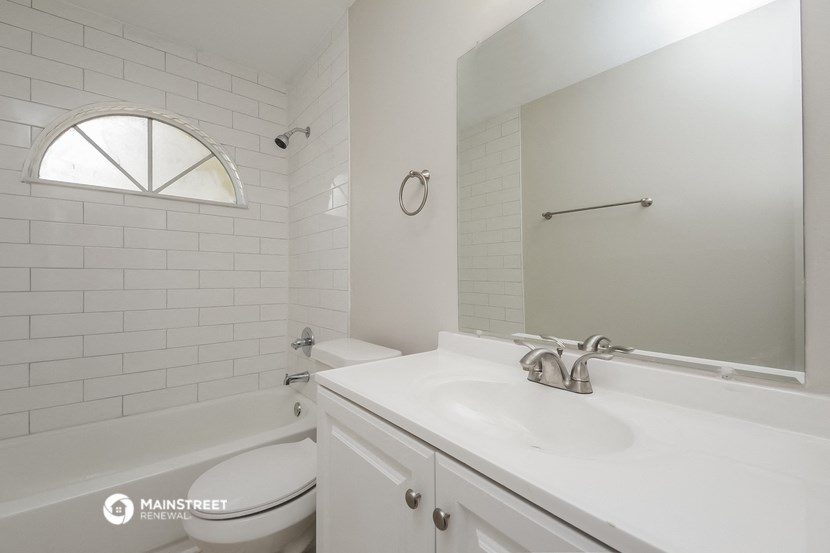 a bathroom with a sink and a toilet and a bath tub