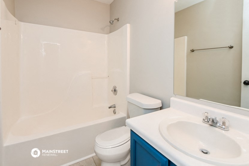 a bathroom with a sink toilet and a shower