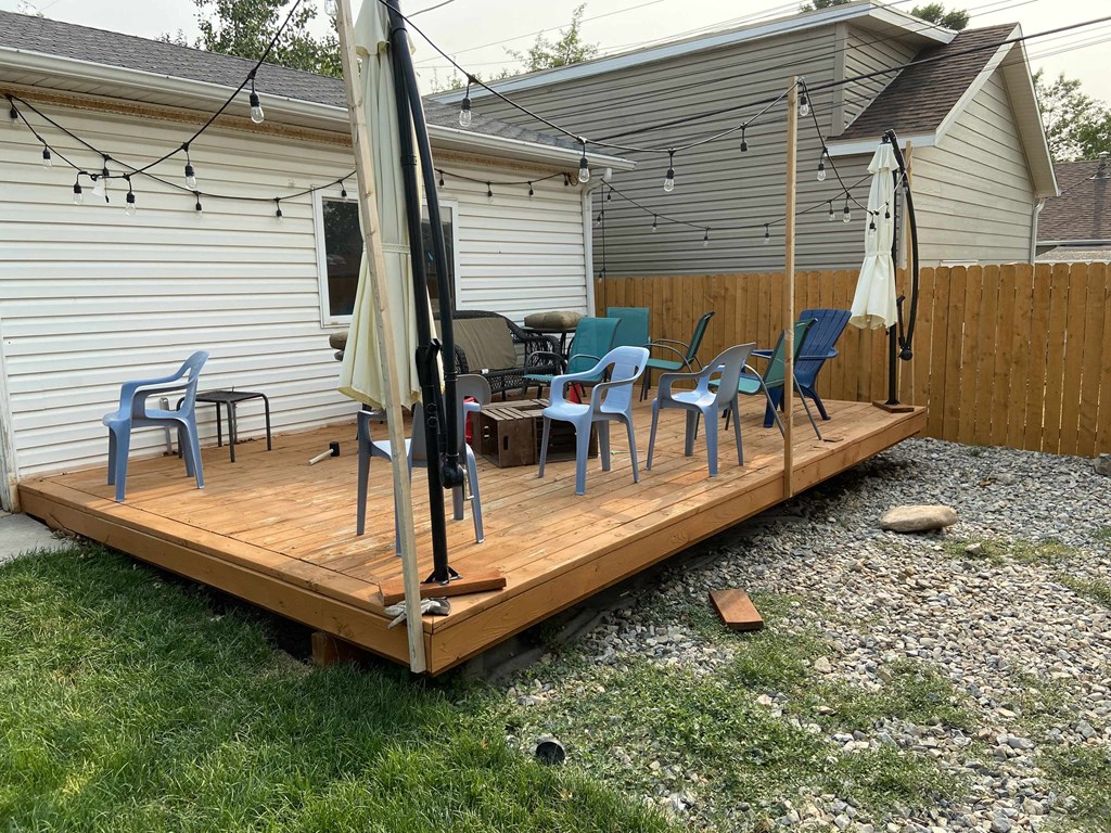 a deck with chairs and a table on it