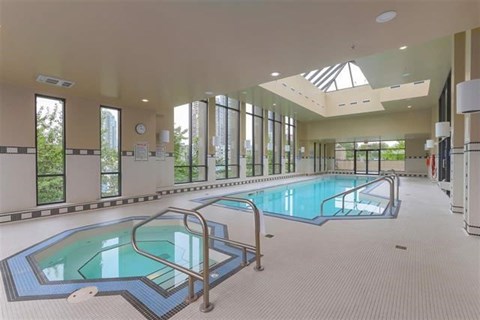 A large indoor swimming pool with a skylight above it.