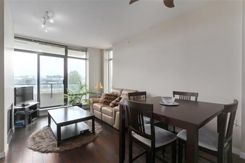 A living room with a brown table and chairs.
