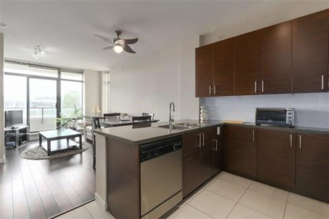 A modern kitchen with a large island and stainless steel appliances.