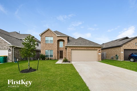 a large brick house with a garage and a driveway