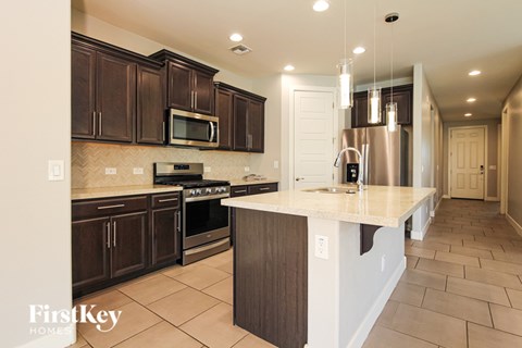 A kitchen with brown cabinets and a white island.