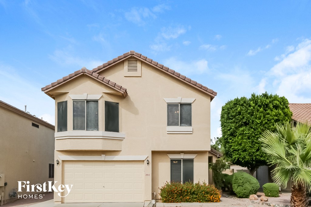 a house with a palm tree in front of it