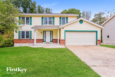 a white house with a driveway and a garage door