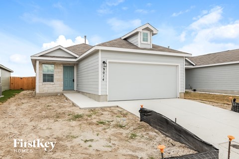 the front of a house with a driveway and a garage door