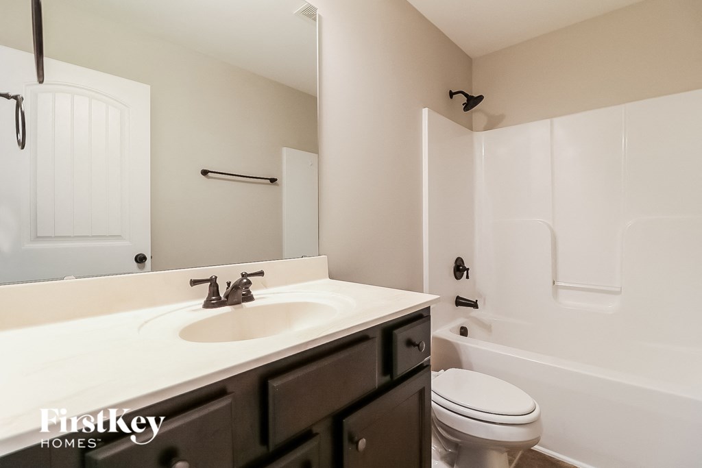 a bathroom with a sink and a toilet and a shower