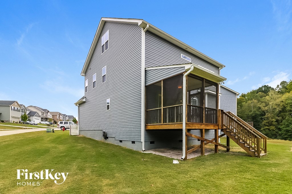 a renovated house with a porch and a deck on a lawn
