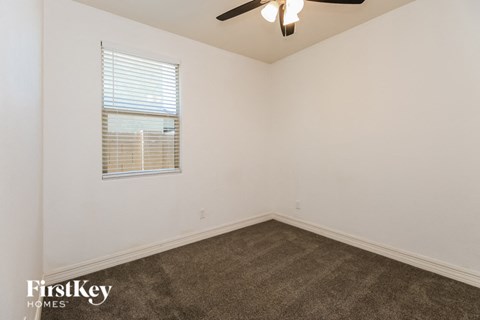 the living room of a home with a carpet and a window