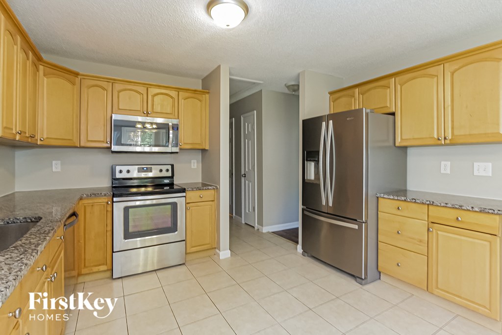 a kitchen with wooden cabinets and stainless steel appliances