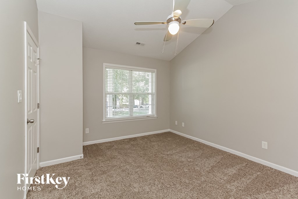 the master bedroom is spacious and has a ceiling fan