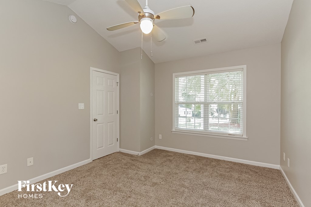 the master bedroom is spacious and has a ceiling fan