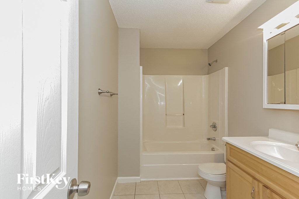 a bathroom with a shower and a sink and a toilet