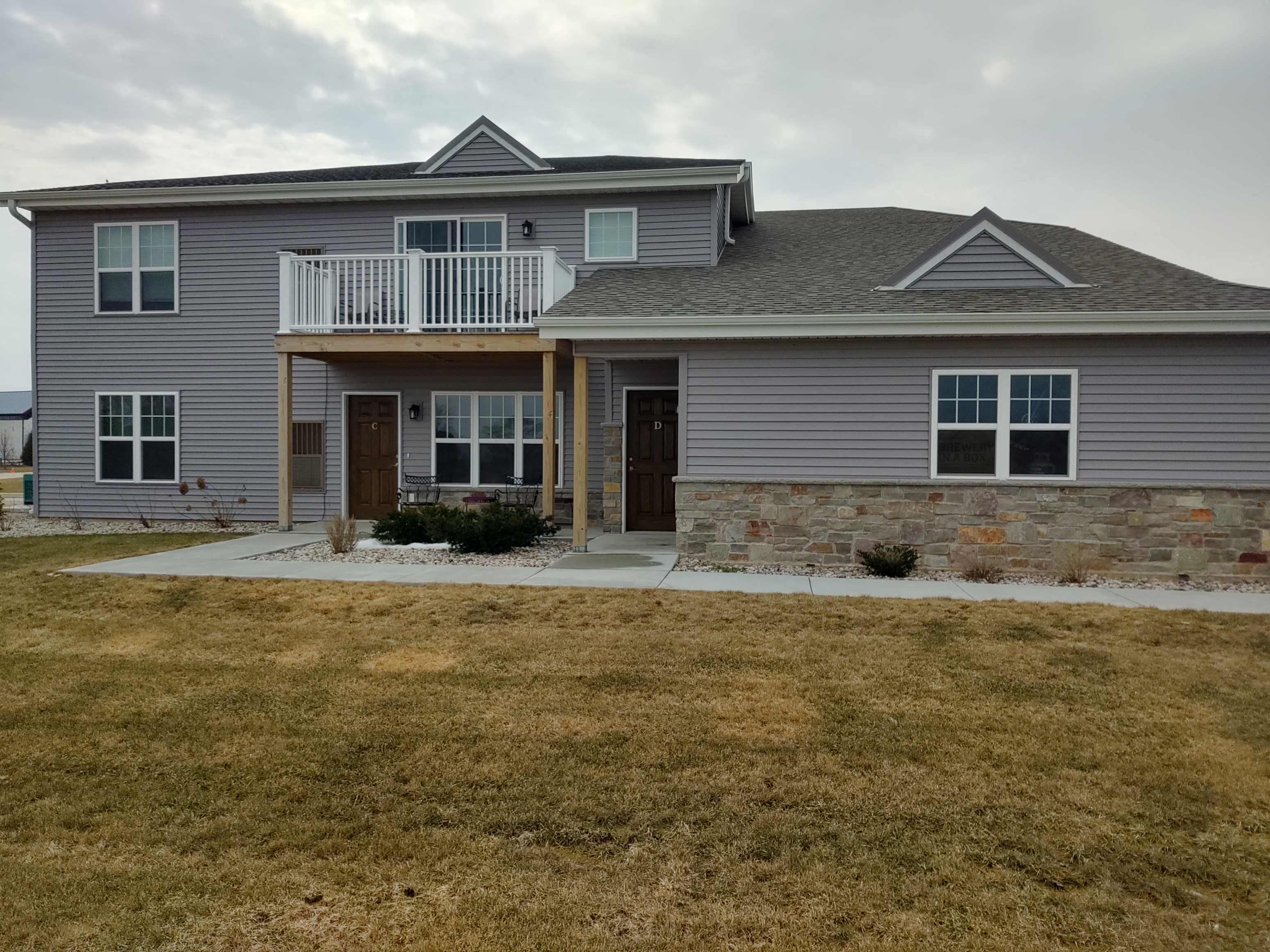a house with a porch and a stone wall