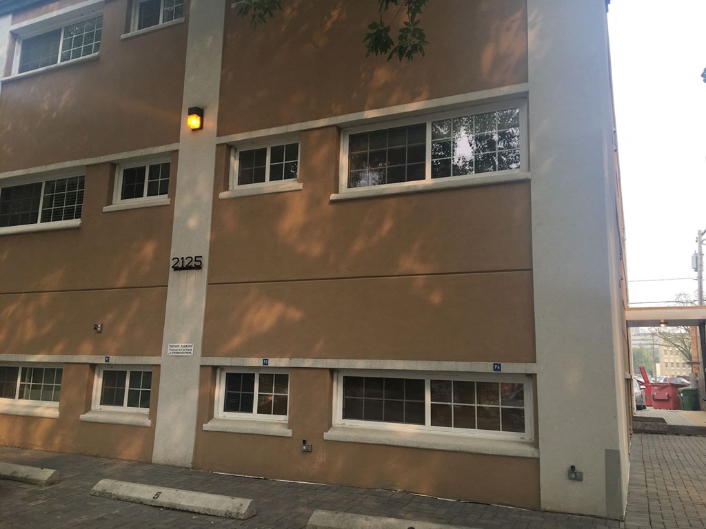 the side of a building with windows and a yellow light