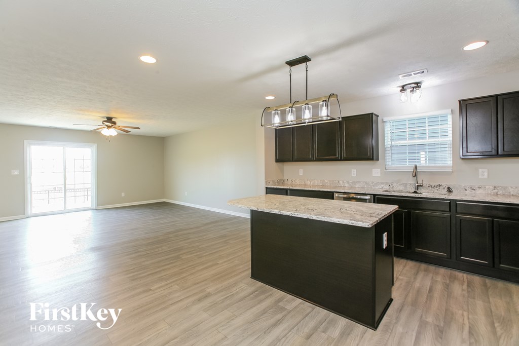 A kitchen with a black counter and cabinets.