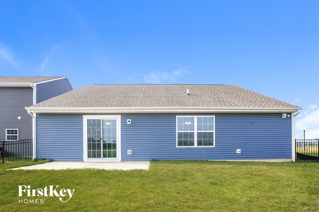 A blue house with the words "FirstKey Homes" on the lawn.