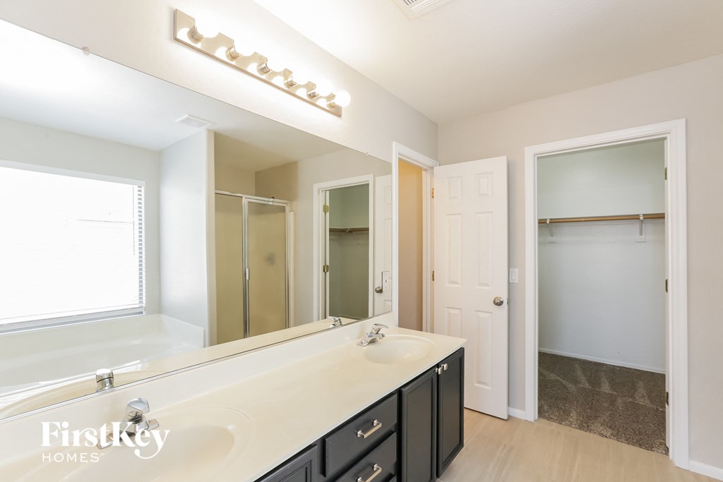 a bathroom with a large mirror and a large sink