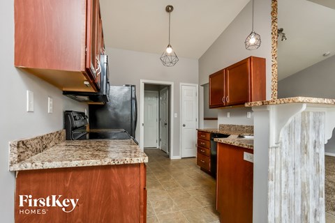 A kitchen with a counter top and a refrigerator.