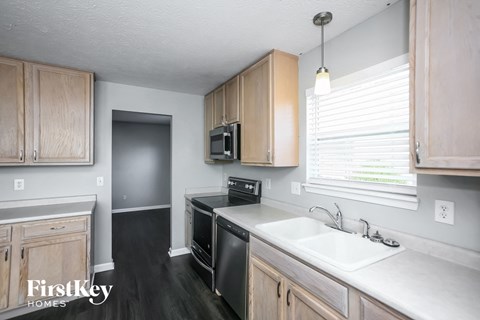 a kitchen with wooden cabinets and a sink and a window