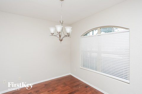 a living room with a large window and a wood floor