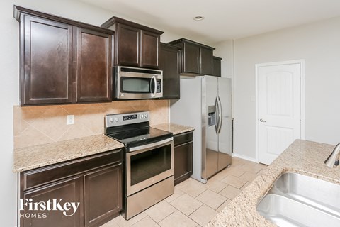 a kitchen with stainless steel appliances and granite counter tops