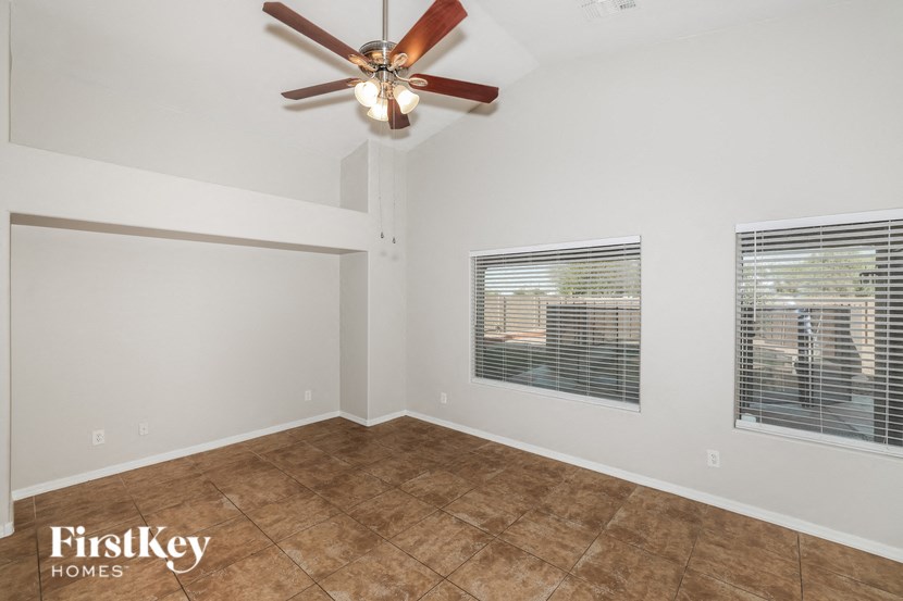 a living room with a ceiling fan and a window