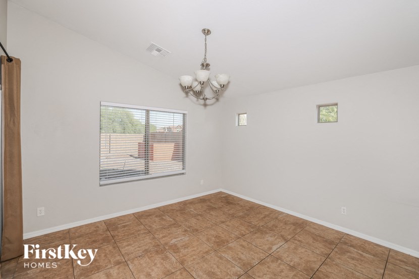 a living room with a chandelier and a window